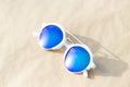 Retro sunglasses model with blue round lenses shoot outside in a sunny day closeup . Selective focus