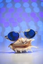 Retro sunglasses with shell and blurry shiny colored background