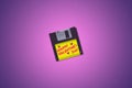 A retro synthwave 1990`s themed old aged floppy disk illustration background with vibrant colors and copy space Royalty Free Stock Photo