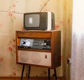 Retro technology, vintage radiogram 1960s and tube tv at home in living room, old school style 1970s