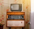 Retro technology, vintage radiogram 1960s and tube tv at home in living room, old school style 1970s