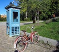 Retro telephone booth and bicycle Royalty Free Stock Photo