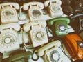 Retro telephones with rotary dials on shelves
