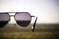 Retro themed sunglasses held in air at Jampore beach of Daman in India