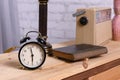 Retro things on table, close upRetro things on table, close up. An old dial phone, a black alarm clock, a table lamp, a book, and Royalty Free Stock Photo