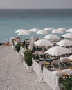 Retro toned beach umbrella with azure blue sea in Nice, France.