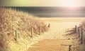 Retro toned photo of a beach path.