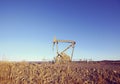 Retro toned picture of an oil pump at sunset Royalty Free Stock Photo