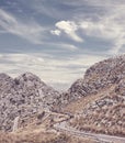 Retro toned picture of a scenic winding mountain road