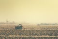 Retro toned tractors on arable field