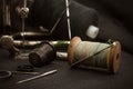 Retro tools for cutting and sewing. Needle with thread, thimble, sewing machine and scissors Royalty Free Stock Photo