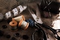 Retro tools for cutting and sewing. Needle with thread, thimble, sewing machine and scissors Royalty Free Stock Photo