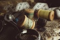Retro tools for cutting and sewing. Needle with thread, thimble, sewing machine and scissors Royalty Free Stock Photo