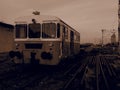 Retro train wagon. Vintage locomotive made in Yugoslavia. Sremska Mitrovica, Serbia. Sepia. The metal body of a railway