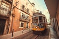 Retro tramway car driving in motion blur past old houses street
