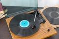 Retro turntable with vinyl record on wooden table Royalty Free Stock Photo