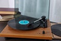 Retro turntable with vinyl record on wooden table Royalty Free Stock Photo