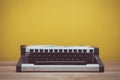 Retro turquoise typewriter on wooden table. Old style