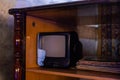 retro tv with wooden case in room with vintage wallpaper and parquet Royalty Free Stock Photo