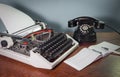 Retro typewriter and old telephone on the table, checkbook, ink pen Royalty Free Stock Photo