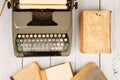 Retro typewriter and old vintage books on white wooden background Royalty Free Stock Photo