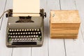 Retro typewriter and old vintage books on white wooden background Royalty Free Stock Photo