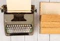 Retro typewriter and old vintage books on white wooden background Royalty Free Stock Photo