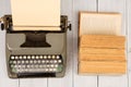 Retro typewriter and old vintage books on white wooden background Royalty Free Stock Photo