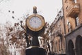 Retro urban business street clock in city center near old building - time saving and fast paced life concept Royalty Free Stock Photo