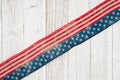 Retro USA stars and stripes burlap ribbon on weathered whitewash wood background Royalty Free Stock Photo