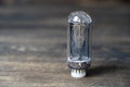 Retro vacuum lamp on a wooden background, close up