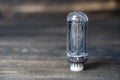 Retro vacuum lamp on a wooden background, close up