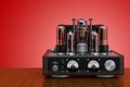 Retro vacuum tube amplifier on the wooden table. 3D rendering Royalty Free Stock Photo