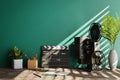 Retro vibe background with green wall behind with movie director slate and old movie projector, 3d