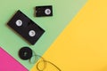 Retro videocassette and film on a three-color pastel paper background. Flat lay, minimal concept