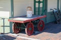 Retro vintage antique railway train warehouse building with red and green luggage wheel card on a red brick loading platform Royalty Free Stock Photo