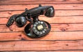 Retro Vintage Black Rotary Telephone On Warped Wooden Slats