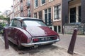 Retro vintage Citroen car from behind parked on the street of Amsterdam on rainy day Royalty Free Stock Photo