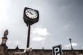 Retro vintage clocktower style street old clock tower in european city scene at daylight under clear sky with desaturated edit. Co Royalty Free Stock Photo