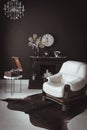 Retro vintage interior. Retro living room interior in dark black colors. Retro leather chair and fireplace Royalty Free Stock Photo