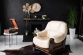 Retro vintage interior. Retro living room interior in dark black colors. Retro leather chair and fireplace Royalty Free Stock Photo