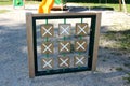 Retro vintage looking outdoor public playground equipment in shape of large wooden frame with x and 0 tiles used to play popular Royalty Free Stock Photo