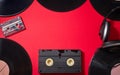 retro vintage music vinyl disks audio cassette video cassette on red background