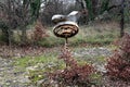 Retro vintage old broken rusted metal street lamp mounted on short metal pole at abandoned public park