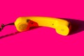 Retro vintage phone handset yellow pink red purple plastic orange disko background old style shadow 90 Royalty Free Stock Photo