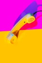 Retro vintage phone handset yellow pink red purple plastic orange disko background old style shadow 90 Royalty Free Stock Photo