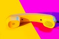 Retro vintage phone handset yellow pink red purple plastic orange disko background old style shadow 90 Royalty Free Stock Photo