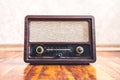 Retro vintage radio. Music nostalgia with old 60s style song player. Dusty speaker and receiver on wood. Knobs and frequency tuner Royalty Free Stock Photo