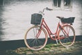 Retro vintage red bicycle on cobblestone street in the old town. Royalty Free Stock Photo