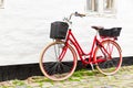 Retro vintage red bicycle on cobblestone street in the old town. Royalty Free Stock Photo